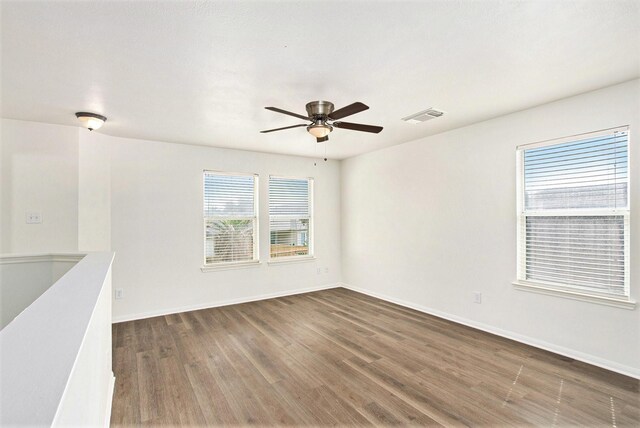 1722 Caldbeck Ln, Fresno, TX 77545 - spare room featuring baseboards, a ceiling fan, wood finished floors, and visible vents