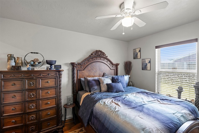 bedroom featuring a ceiling fan and dark wood-type flooring
