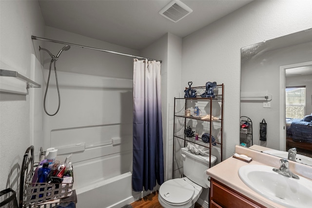 full bath featuring wood finished floors, vanity, shower / tub combo, toilet, and visible vents