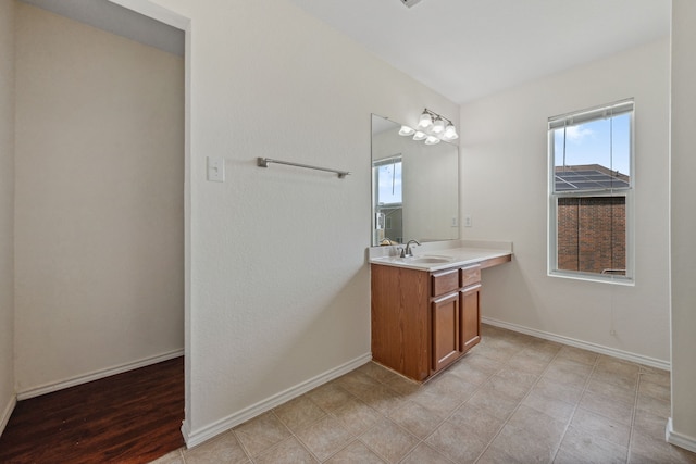 bathroom with baseboards and vanity
