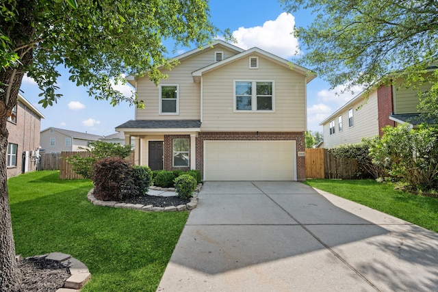 traditional-style house featuring brick siding, fence, a front yard, concrete driveway, and an attached garage