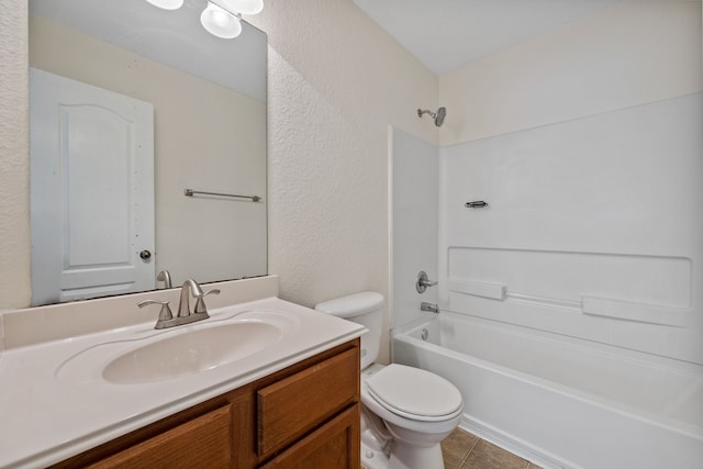 full bathroom with a textured wall, toilet, shower / bathing tub combination, vanity, and tile patterned flooring
