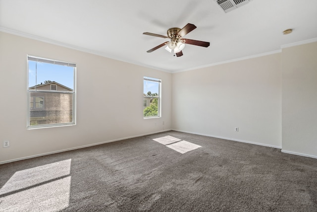 empty room with carpet flooring, ceiling fan, crown molding, visible vents, and baseboards