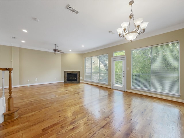 12620 Briar Patch Rd, Houston, TX 77077 - unfurnished living room with a fireplace, visible vents, ornamental molding, and ceiling fan with notable chandelier