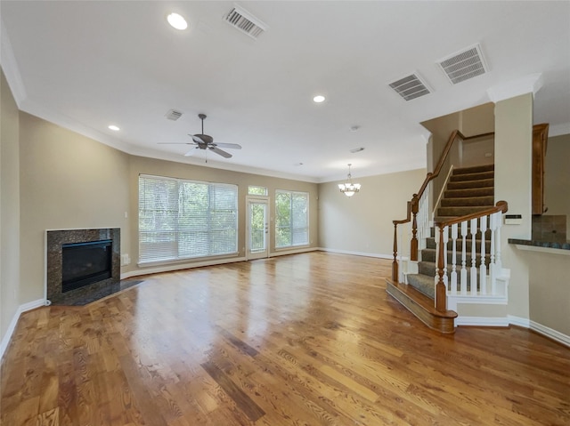 12620 Briar Patch Rd, Houston, TX 77077 - unfurnished living room with ornamental molding, wood finished floors, visible vents, and stairway