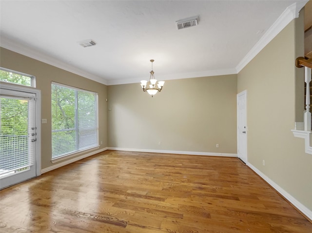 12620 Briar Patch Rd, Houston, TX 77077 - unfurnished dining area with a chandelier, light wood-style flooring, visible vents, and ornamental molding