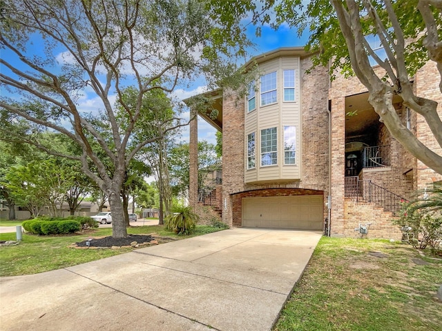 12620 Briar Patch Rd, Houston, TX 77077 - view of front of home featuring concrete driveway, a front lawn, a garage, brick siding, and stairs