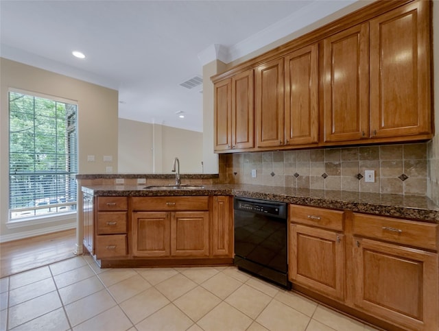 12620 Briar Patch Rd, Houston, TX 77077 - kitchen featuring dishwasher, brown cabinets, a sink, and visible vents