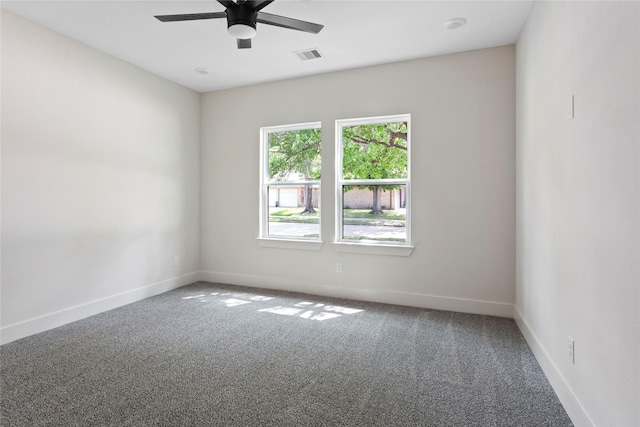 empty room featuring baseboards, visible vents, carpet floors, and ceiling fan