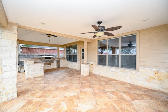 view of patio / terrace with a ceiling fan, exterior kitchen, and fence