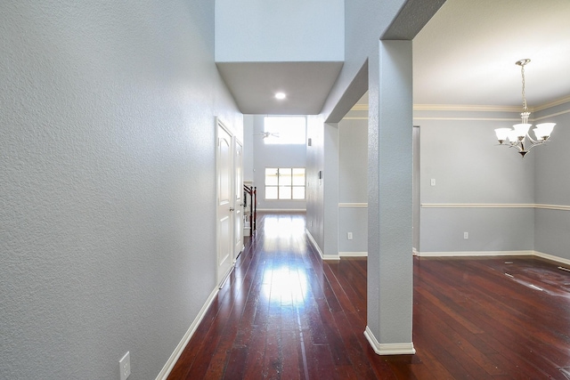 1106 Windsor Chase Ln, Spring, TX 77373 - hall with wood-type flooring, a chandelier, a textured wall, and baseboards
