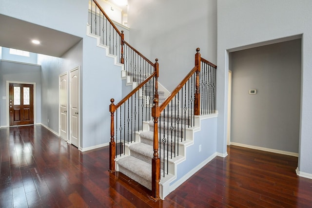 1106 Windsor Chase Ln, Spring, TX 77373 - stairway with hardwood / wood-style floors, a towering ceiling, and baseboards