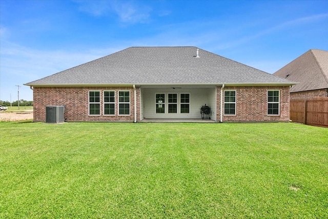 9345 Phelan Blvd, Beaumont, TX 77706 - rear view of property with central AC unit, brick siding, and ceiling fan