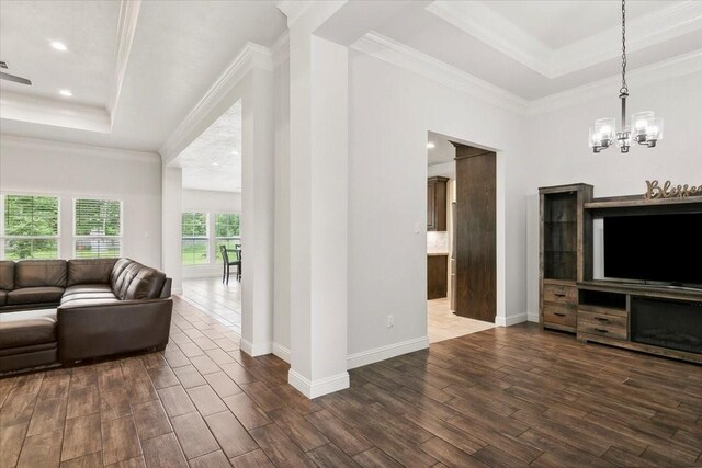 9345 Phelan Blvd, Beaumont, TX 77706 - living area with ornamental molding, dark wood-style floors, a chandelier, and a raised ceiling