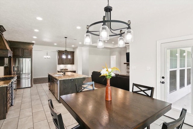 9345 Phelan Blvd, Beaumont, TX 77706 - dining area featuring recessed lighting, baseboards, light tile patterned flooring, and an inviting chandelier