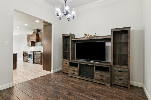 9345 Phelan Blvd, Beaumont, TX 77706 - unfurnished living room with a notable chandelier, baseboards, ornamental molding, and wood finished floors