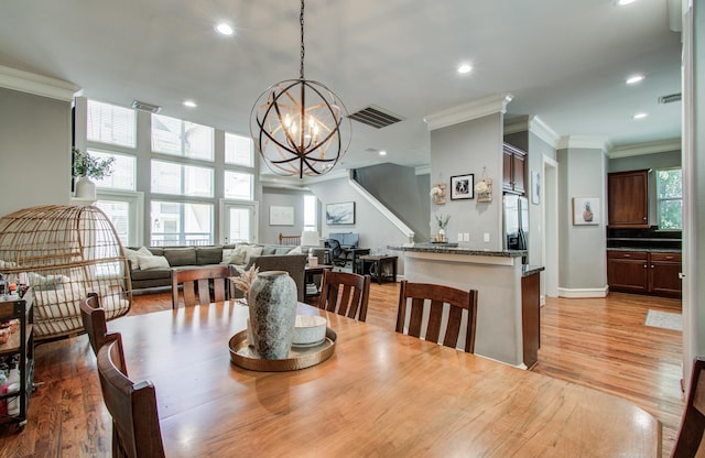 dining space featuring ornamental molding, a chandelier, visible vents, and recessed lighting