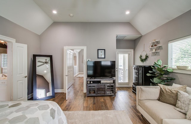 bedroom featuring vaulted ceiling, wood finished floors, and multiple windows