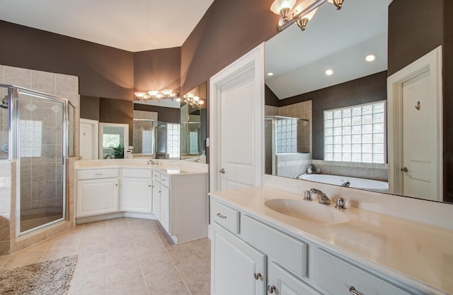 full bath with a chandelier, a shower stall, tile patterned floors, and a sink