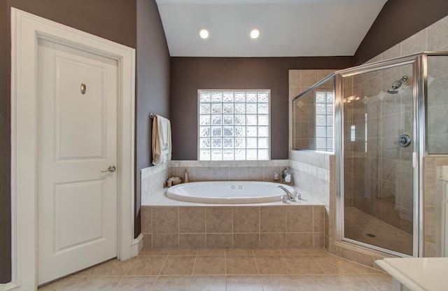 full bath with recessed lighting, lofted ceiling, tile patterned flooring, a garden tub, and a stall shower