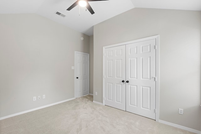 1020 Jefferson St, Alvin, TX 77511 - unfurnished bedroom featuring lofted ceiling, visible vents, a closet, and light colored carpet