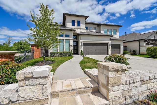 prairie-style house with a garage, driveway, stone siding, and stucco siding