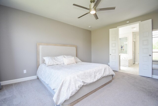 bedroom featuring ensuite bath, baseboards, a ceiling fan, and carpet flooring