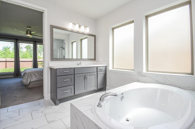 full bath featuring marble finish floor, a ceiling fan, vanity, a garden tub, and a shower