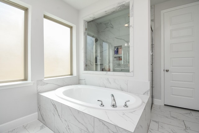 bathroom featuring baseboards, a garden tub, a marble finish shower, and marble finish floor