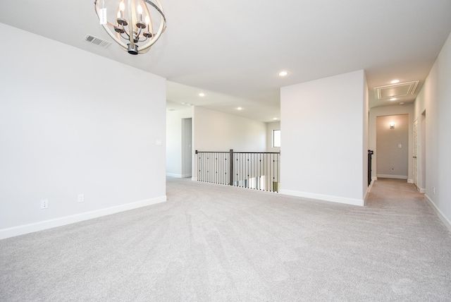 empty room with attic access, light carpet, visible vents, and recessed lighting