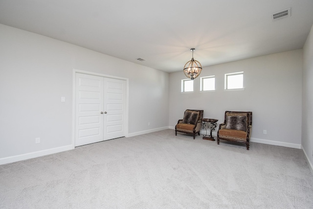 living area featuring baseboards, a notable chandelier, visible vents, and carpet