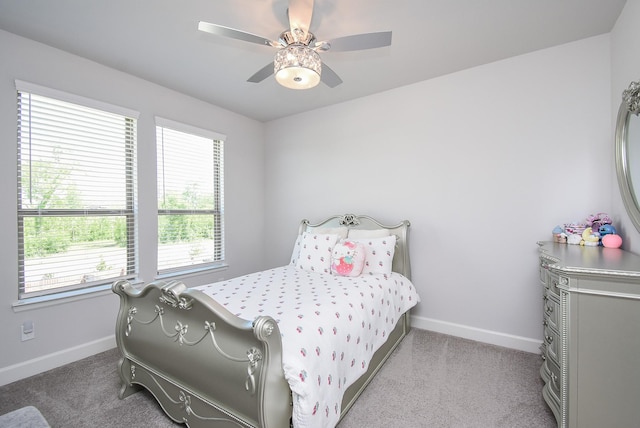 carpeted bedroom featuring baseboards and ceiling fan