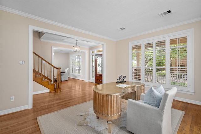 sitting room with baseboards, stairs, ornamental molding, and wood finished floors