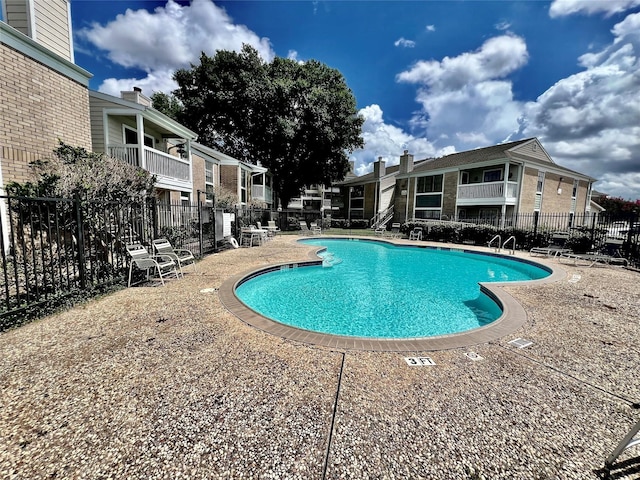 12660 Ashford Point Dr Unit 302, Houston, TX 77082 - community pool featuring a patio and fence