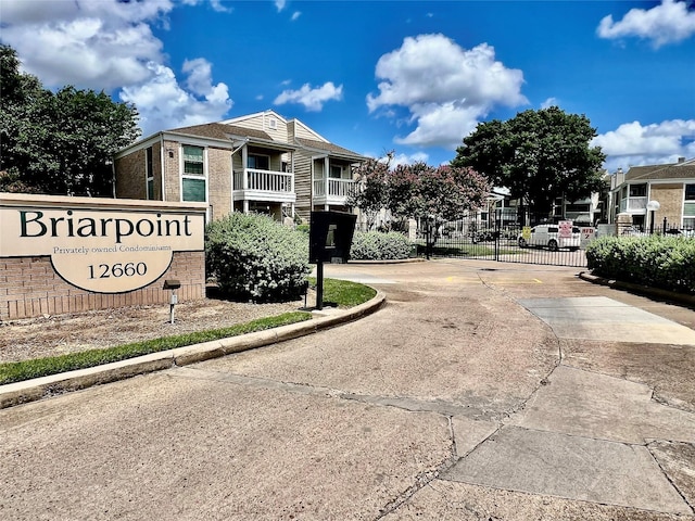 12660 Ashford Point Dr Unit 302, Houston, TX 77082 - community sign with fence and curved driveway