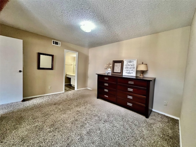 12660 Ashford Point Dr Unit 302, Houston, TX 77082 - carpeted bedroom featuring a textured ceiling, visible vents, baseboards, and ensuite bath