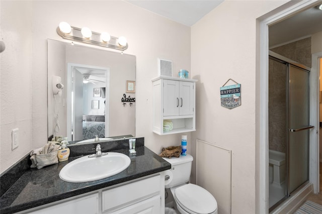 9520 Seawall Blvd Unit 226, Galveston, TX 77554 - ensuite bathroom featuring toilet, a stall shower, a ceiling fan, vanity, and connected bathroom