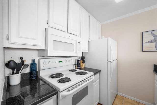 9520 Seawall Blvd Unit 226, Galveston, TX 77554 - kitchen with dark countertops, white appliances, and white cabinetry