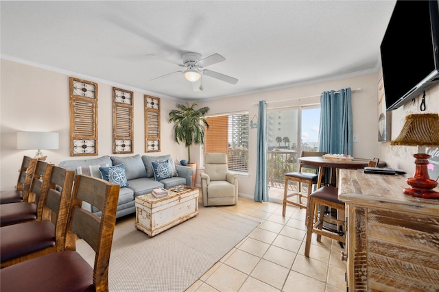 9520 Seawall Blvd Unit 226, Galveston, TX 77554 - living room featuring ceiling fan, crown molding, and light tile patterned floors