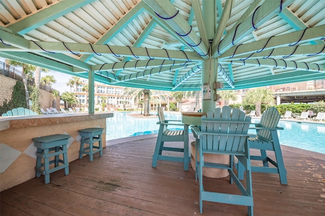 9520 Seawall Blvd Unit 226, Galveston, TX 77554 - wooden deck featuring a community pool and outdoor dry bar