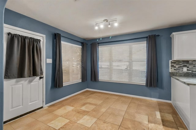 17031 Pelorus Way, Crosby, TX 77532 - unfurnished dining area with baseboards and light tile patterned flooring