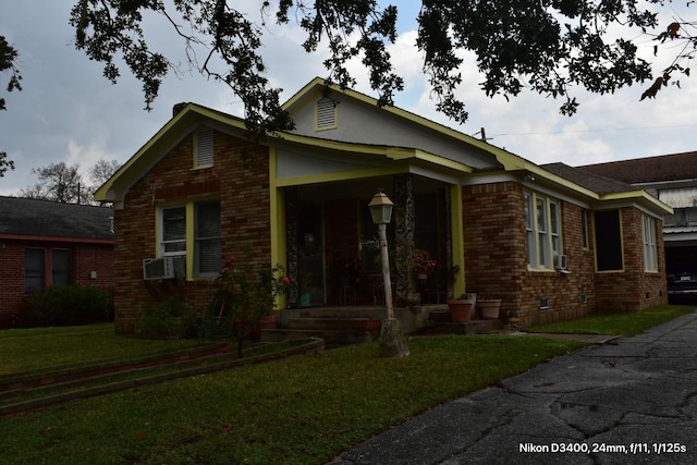 view of front of house with cooling unit, a porch, brick siding, crawl space, and a front yard