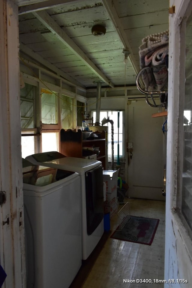 clothes washing area featuring washing machine and clothes dryer and laundry area