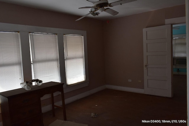 empty room with baseboards and a ceiling fan