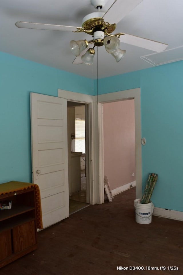 bedroom with attic access, wood finished floors, and ceiling fan