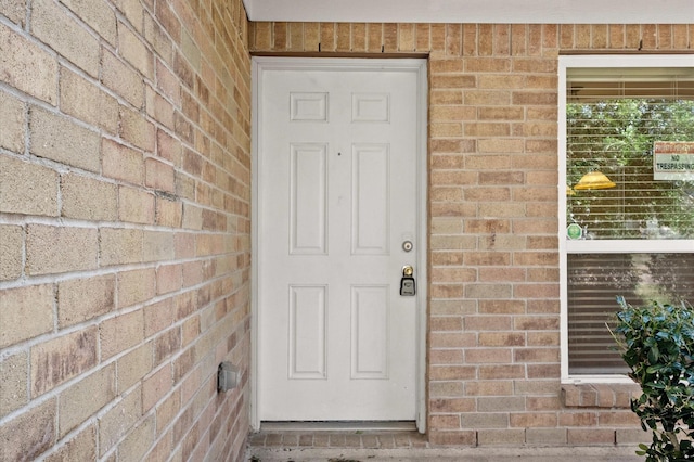 entrance to property with brick siding