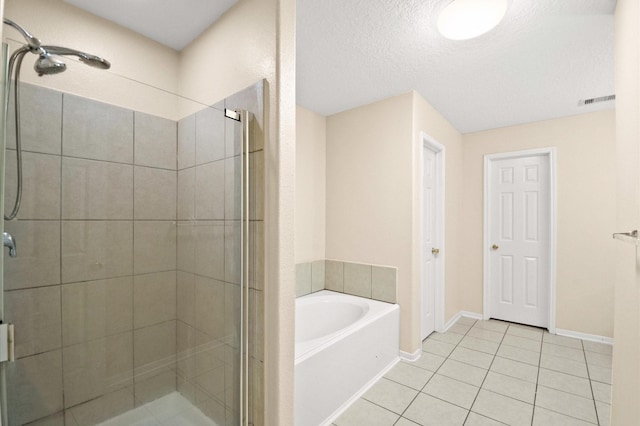 full bathroom with a shower stall, tile patterned floors, visible vents, a bath, and baseboards