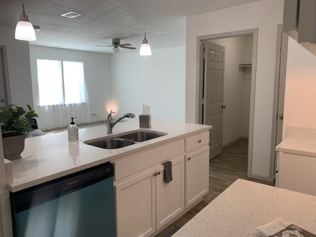 4533 Rosemont St, Houston, TX 77051 - kitchen with white cabinets, stainless steel dishwasher, a sink, dark wood-style flooring, and visible vents