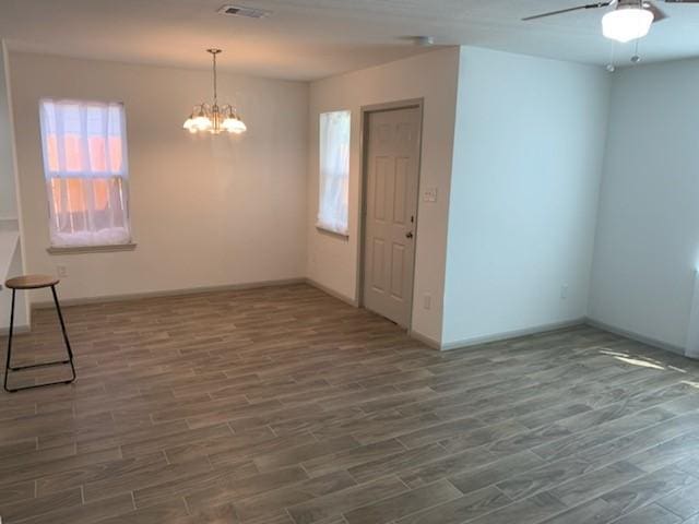 4533 Rosemont St, Houston, TX 77051 - spare room with ceiling fan with notable chandelier, baseboards, wood finished floors, and visible vents