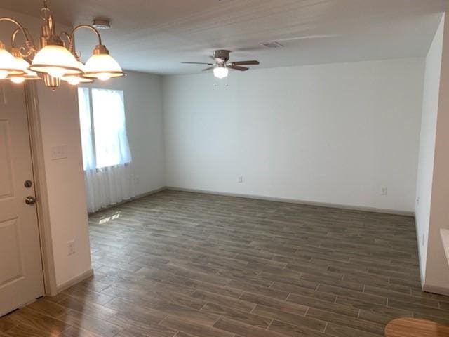 4533 Rosemont St, Houston, TX 77051 - spare room featuring wood finished floors, baseboards, and ceiling fan with notable chandelier